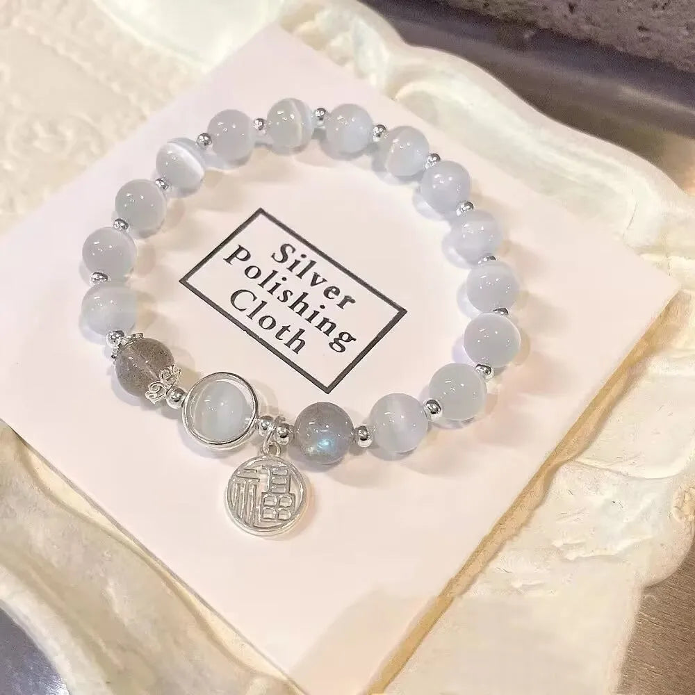 Handmade glass butterfly charm bracelet for women in a drop shape with round details.