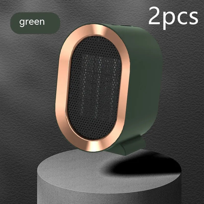 Compact black desktop electric ceramic fan heater with mechanical controls on a wooden desk