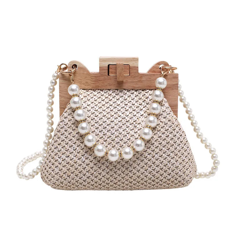 Women's straw shoulder bag with pearl chain strap in beige colour showing organised interior with compartments
