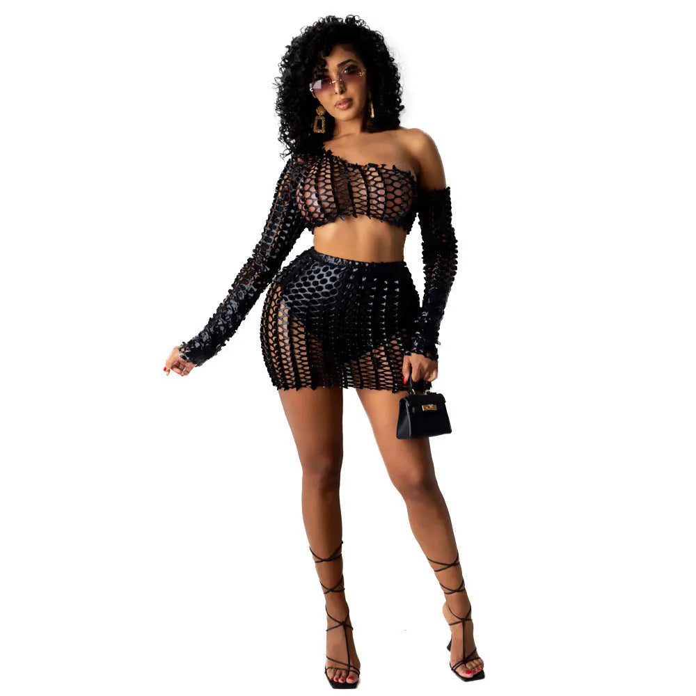 Black hollow-out two-piece dress set with sleeveless top and short skirt on a mannequin.