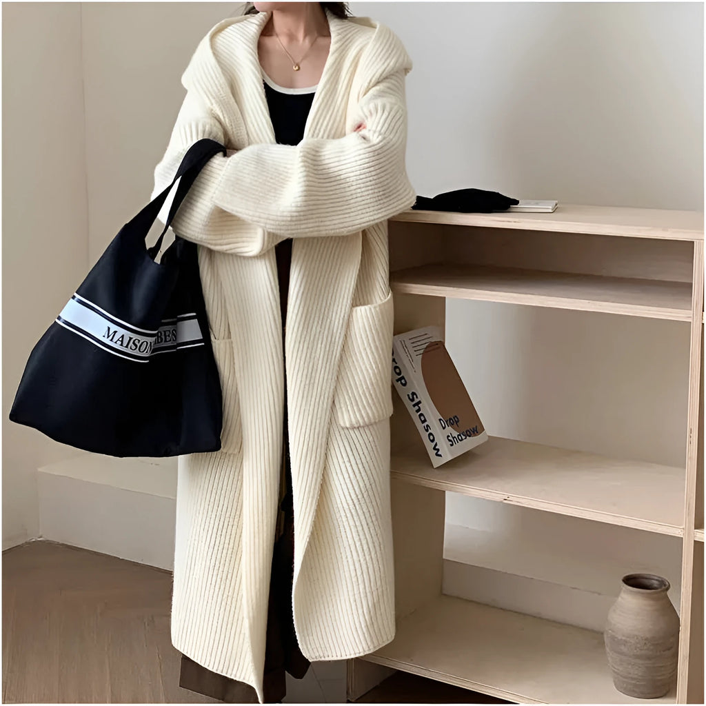 Loose hooded acrylic cardigan coat for women in beige, showing long length and raglan sleeves.