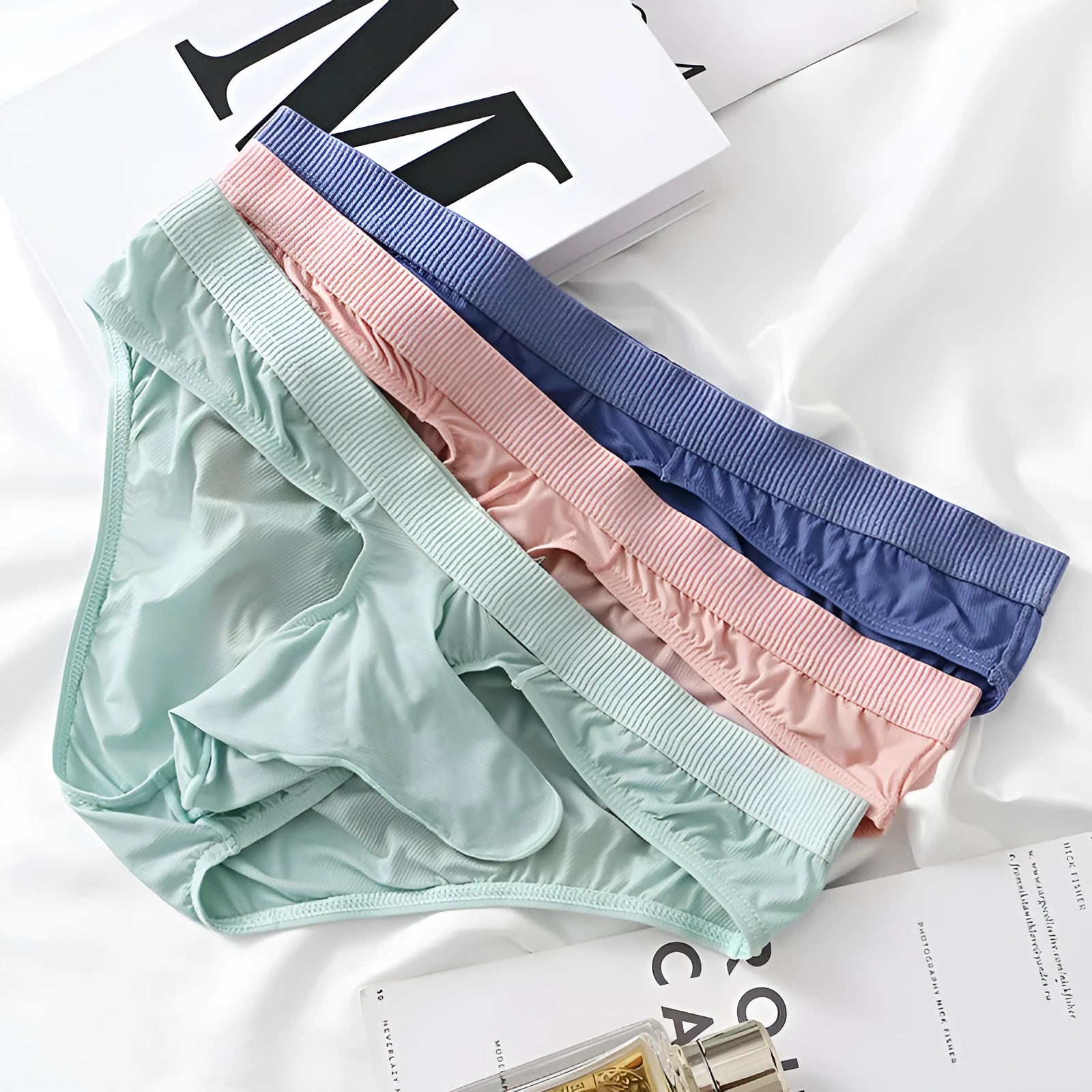 Men's low waist ice silk briefs underwear in multiple colour options showing fabric texture and briefs design