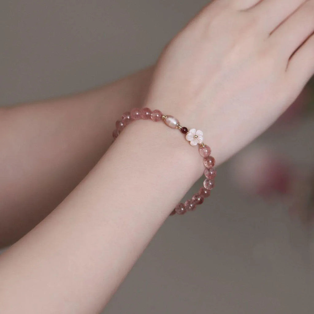 Women's casual crystal bracelet with a strawberry quartz peach blossom flower charm.