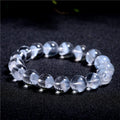 Women's natural white crystal pyramid ghost bracelet with Ruyi charm showing bead texture