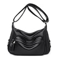 Blue women's large crossbody shoulder bag with multiple internal compartments and soft horizontal square design