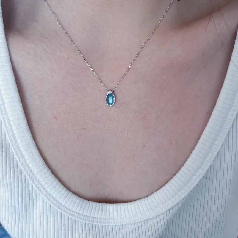 Women's navy blue geometric water drop necklace on adjustable cross chain