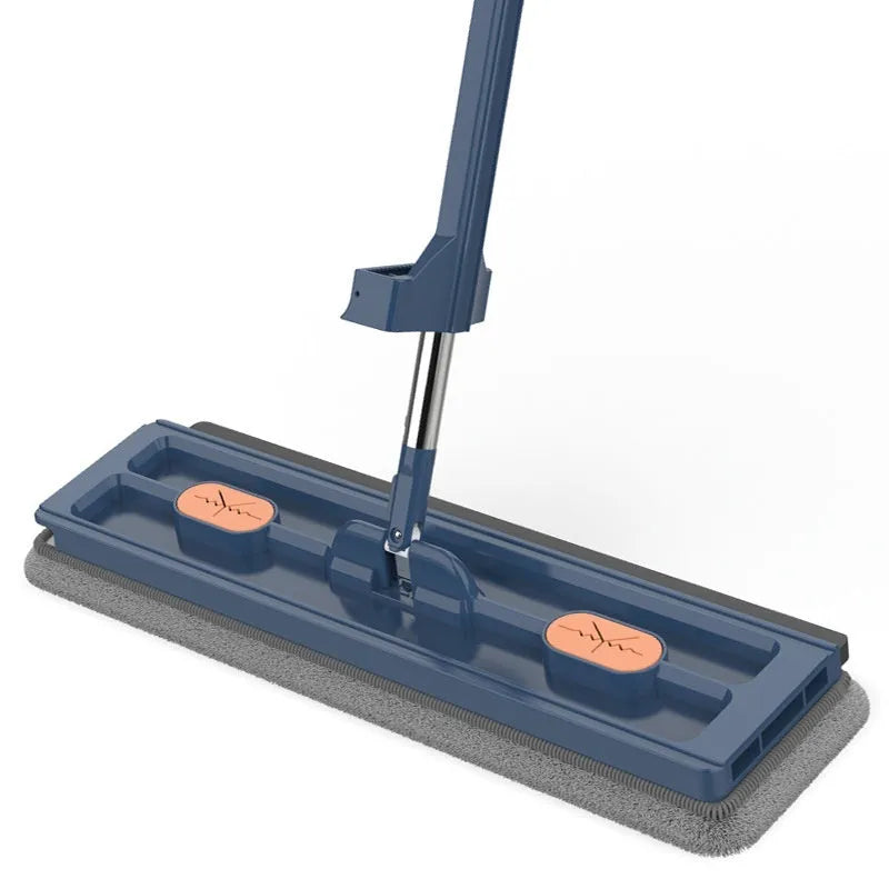 Large flat mop with long stainless steel handle and blue cleaning cloth on a hard floor.