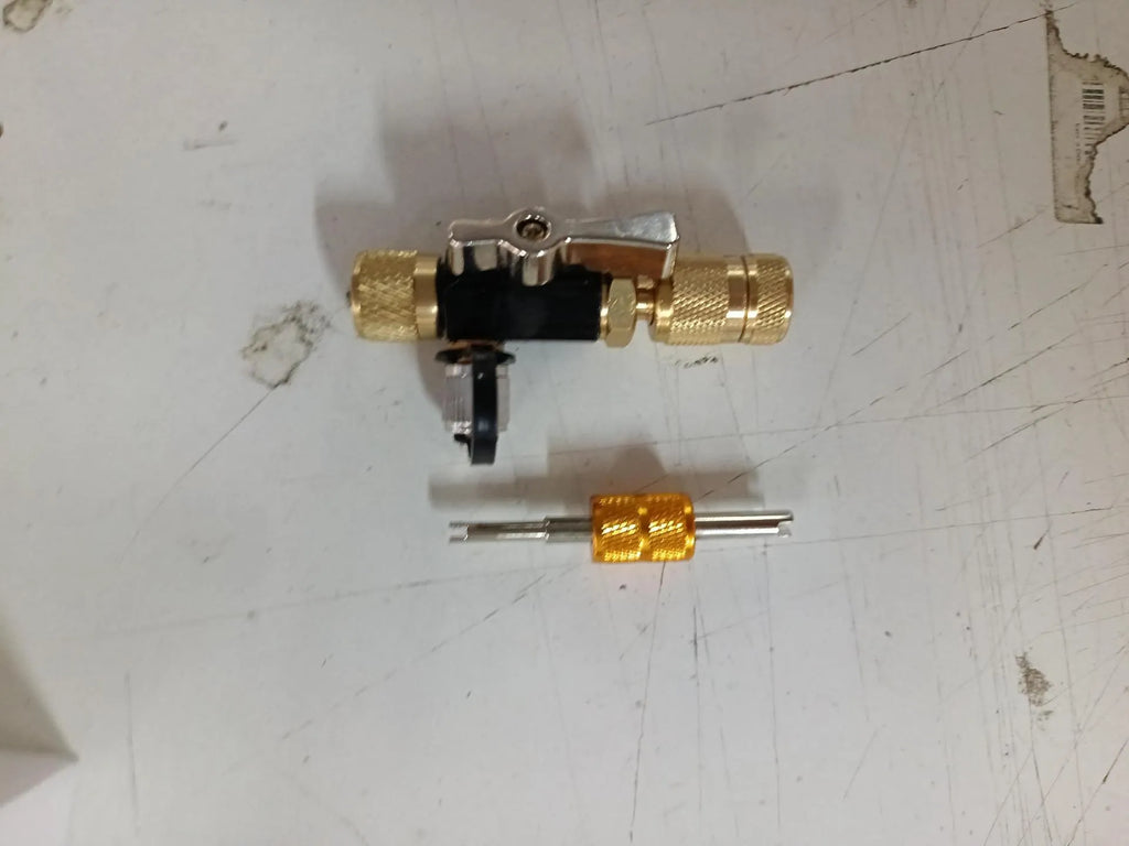 Bicycle tyre valve core disassembly tool set with black and pink removers and a small wrench.