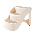 Foldable plastic step ladder for small pets on a wooden floor beside a sofa.