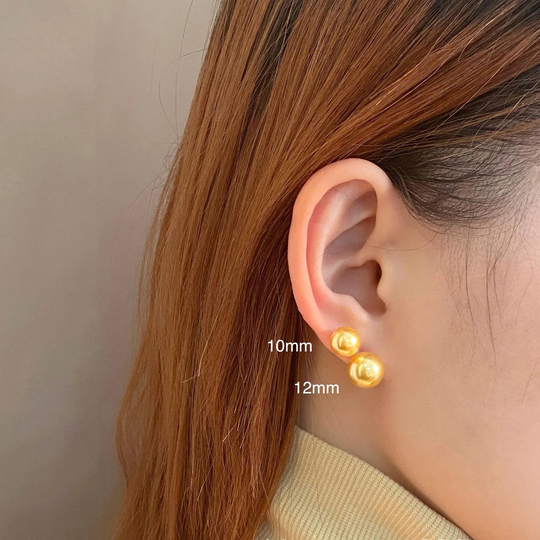A pair of large geometric pearl stud earrings for women in silver, showing an eight-point star design detail.