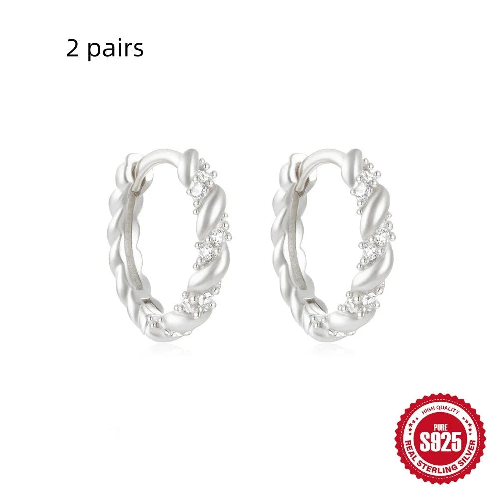 Small round geometric sterling silver stud earrings with a diamond shape, available in gold or silver finish.