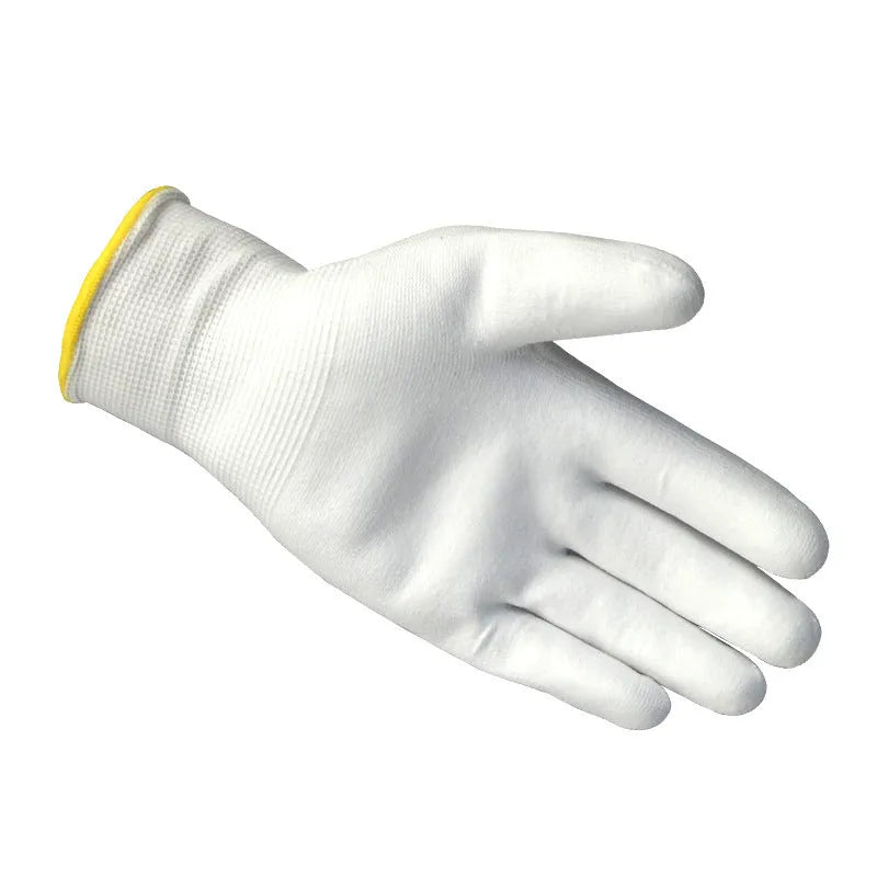 White PU coated labour gloves showing textured palm grip, medium and large sizes on a workbench.