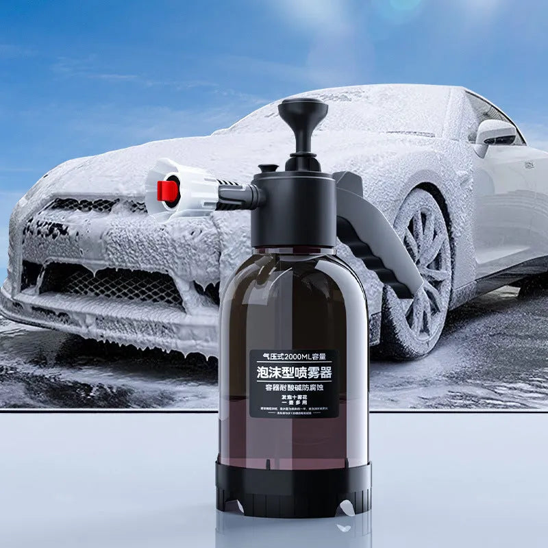 Black hand-held spray sprayer with 2 litre capacity, ergonomic handle, and two nozzles for watering and cleaning.