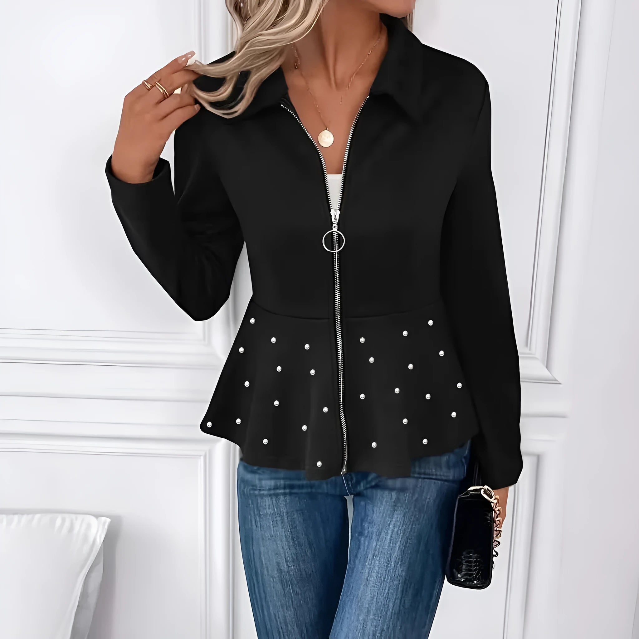 Women's black loose fit coat with beaded zipper and ruffle hem on a hanger.