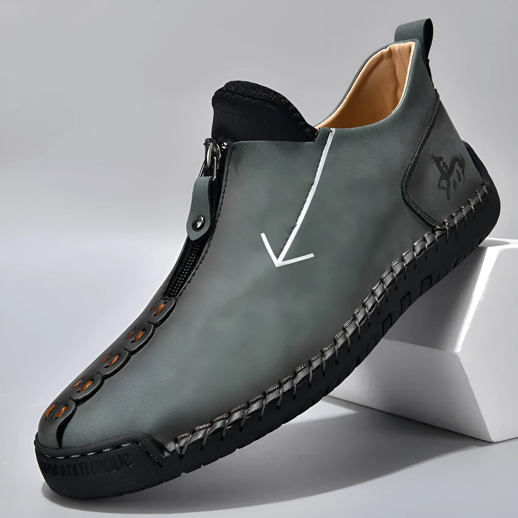 Men's black casual ankle boots with a front zip closure and visible stitching detail