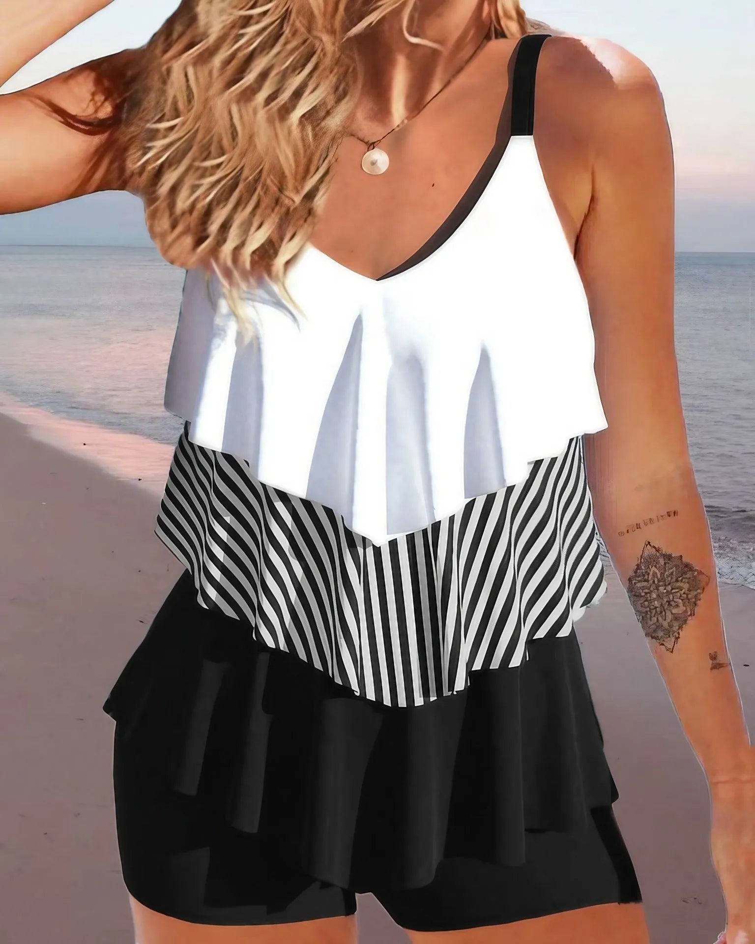 Women's sleeveless spaghetti-strap bikini with ruffle trim and split-side briefs in a floral print.