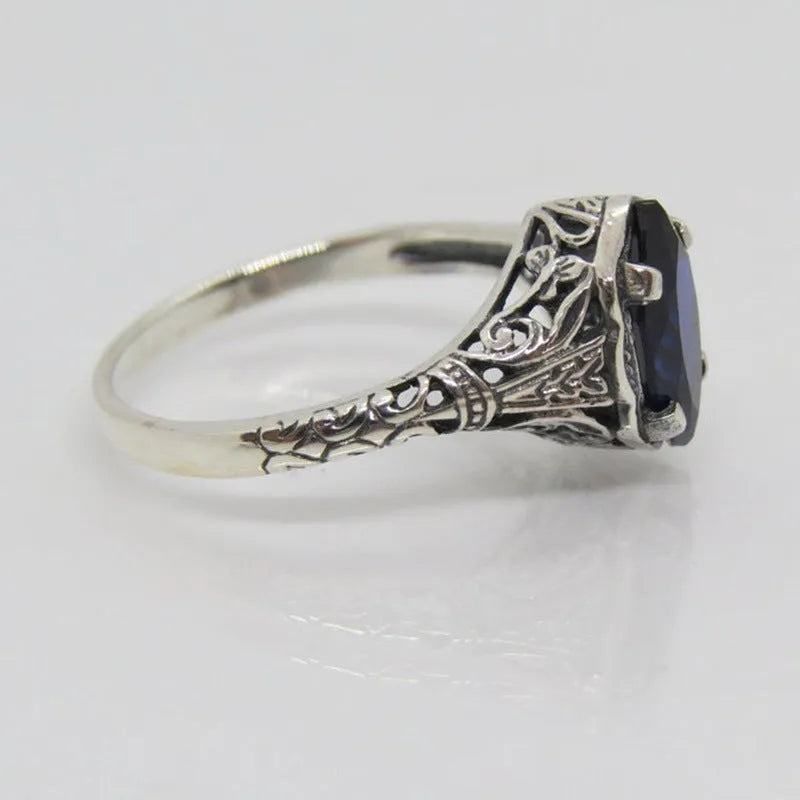 Women's geometric hollow ring in electroplated silver with zircon detail, showing openwork pattern