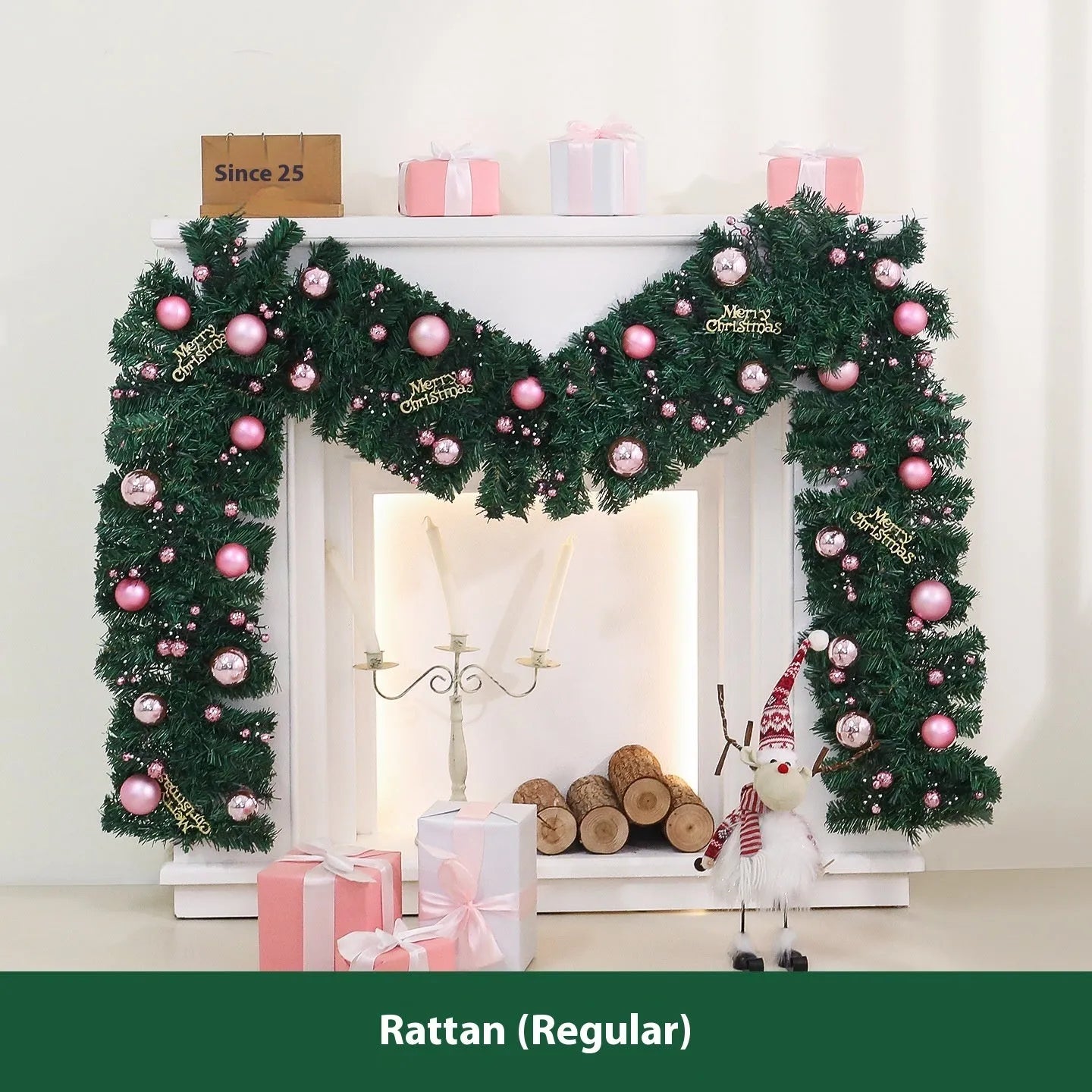 Pink artificial rattan Christmas garland with small fruit details and warm white LED lights, coiled to show its 2.7m length.