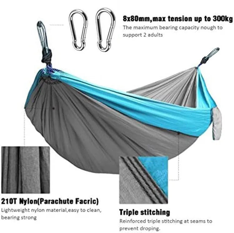 Blue nylon parachute cloth outdoor hammock with reinforced stitching hung between trees