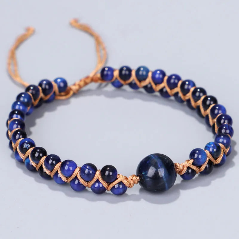 Handmade woven geometric bracelet with a blue Tigereye stone bead and pull design.