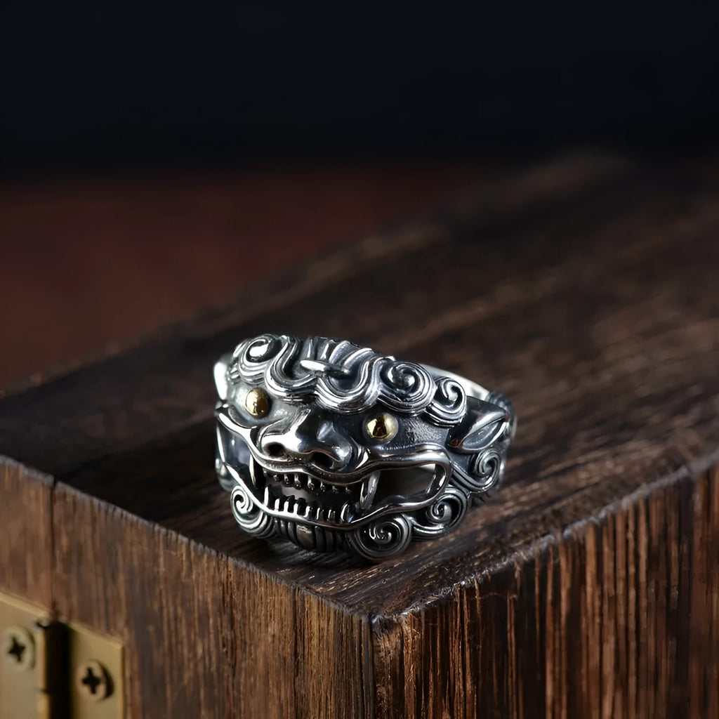 Silver open ring with detailed Jibeast zodiac animal pattern, shown on a hand.