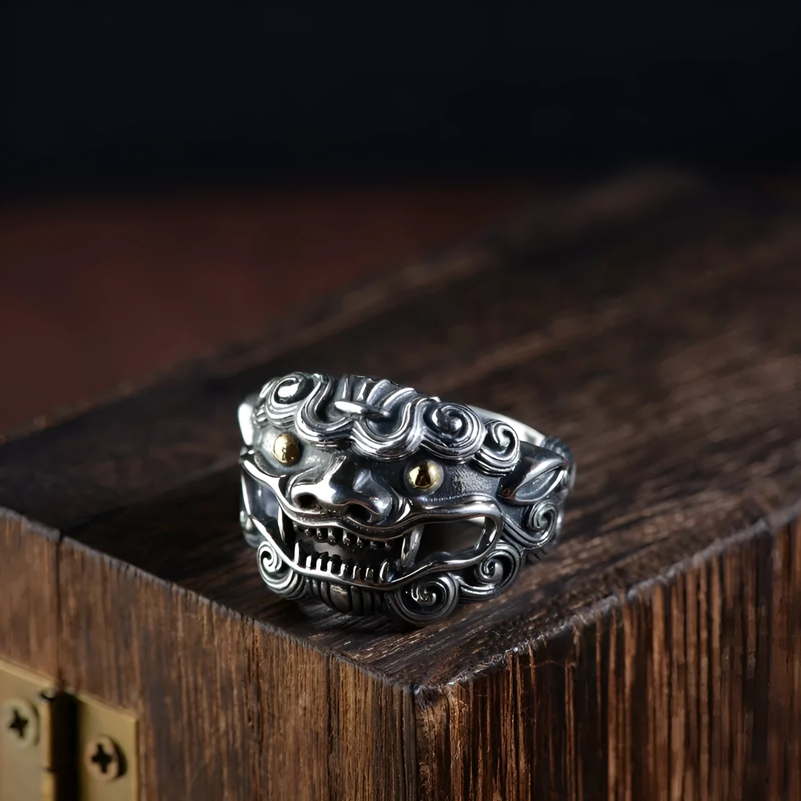 Silver open ring with detailed Jibeast zodiac animal pattern, shown on a hand.