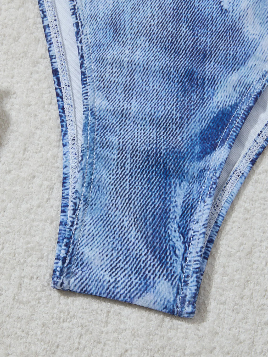 Women's denim blue printed bikini set with adjustable straps on mannequin