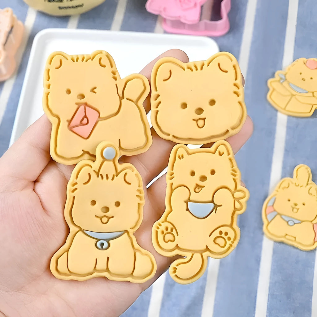 Three dimensional plastic biscuit mould showing puppy cartoon designs including birthday hats and swimming rings