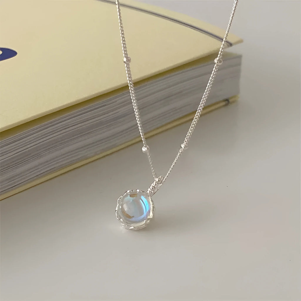 Silver necklace with geometrical ornamental stone pendant on an adjustable curb chain.