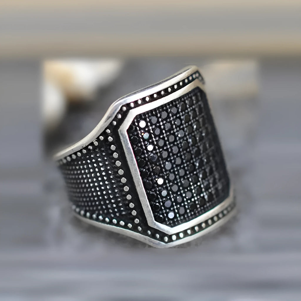 Black alloy ring with copper inlaid detailing around zircon stone in European style