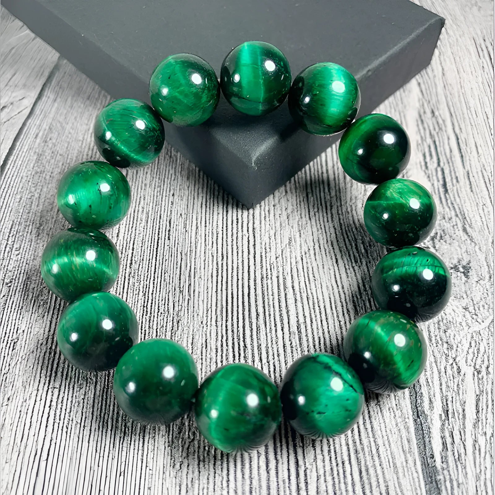 Polished green tiger eye stone bracelet with geometric beads in various sizes on wrist