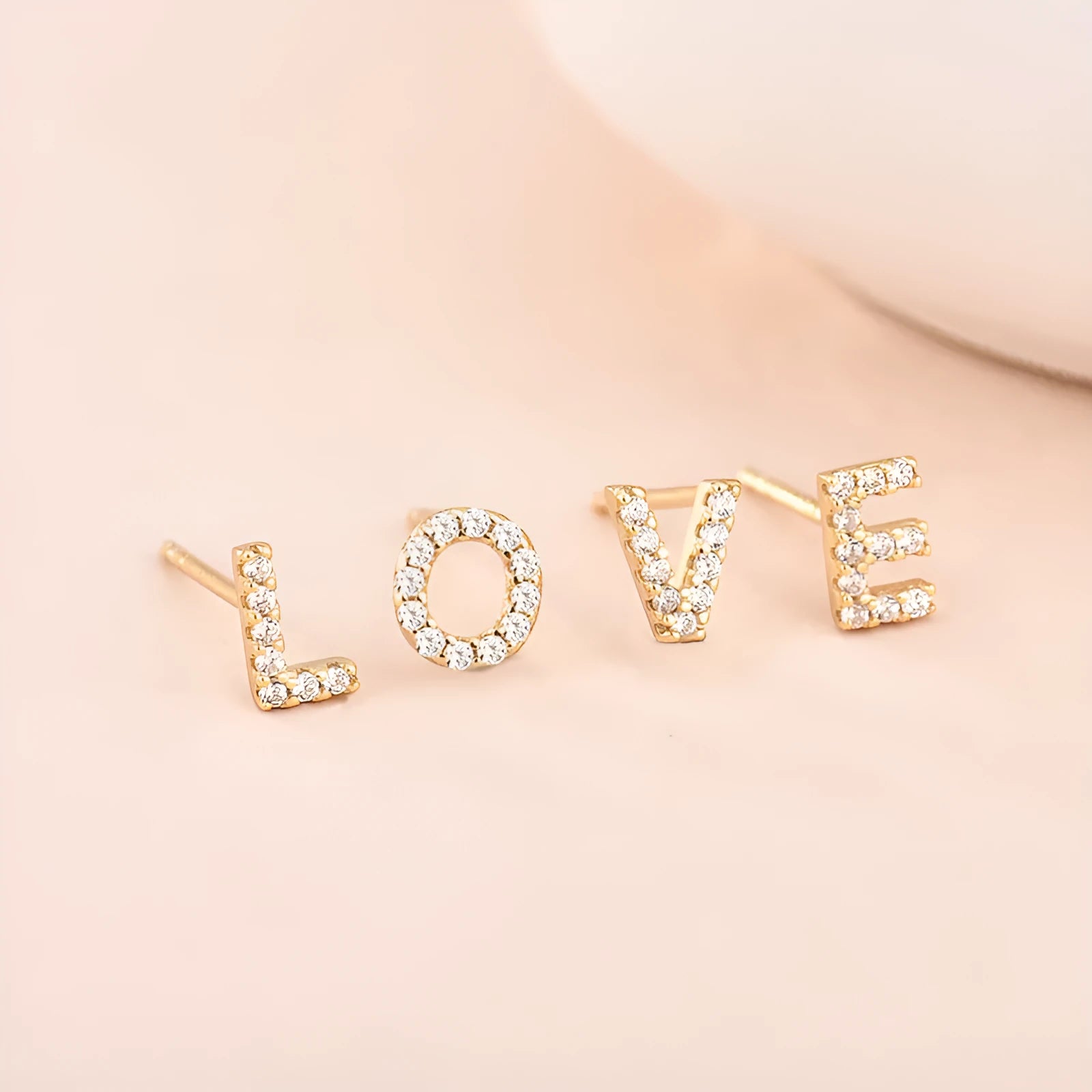 Brass gold plated alphabet letter earrings showing English character design with zircon elements