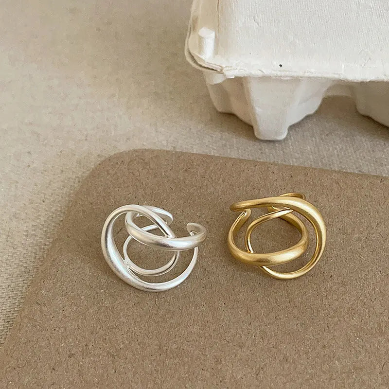 Geometric interlaced matte metal open ring for women in gold or silver.