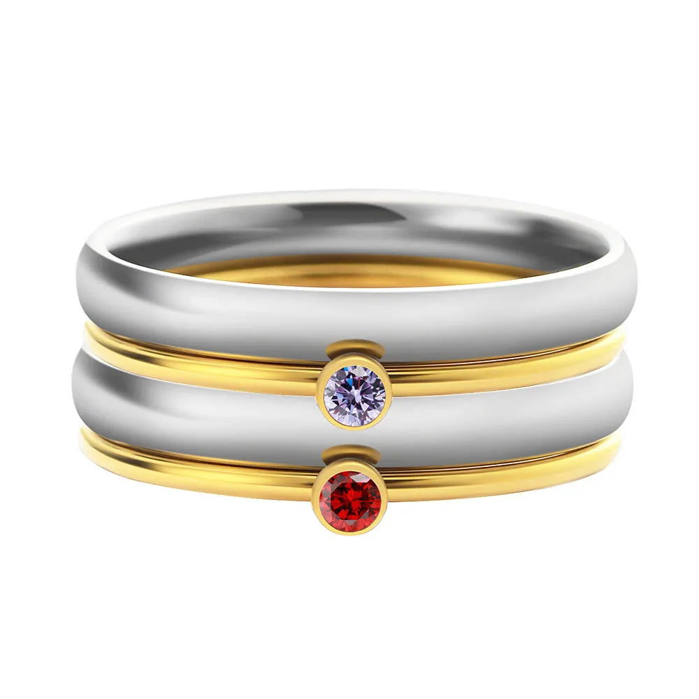 Geometric December birthstone engraved ring in titanium steel on a plain background.
