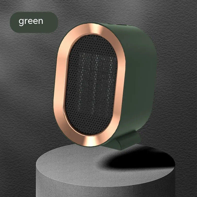 Compact black desktop electric ceramic fan heater with mechanical controls on a wooden desk