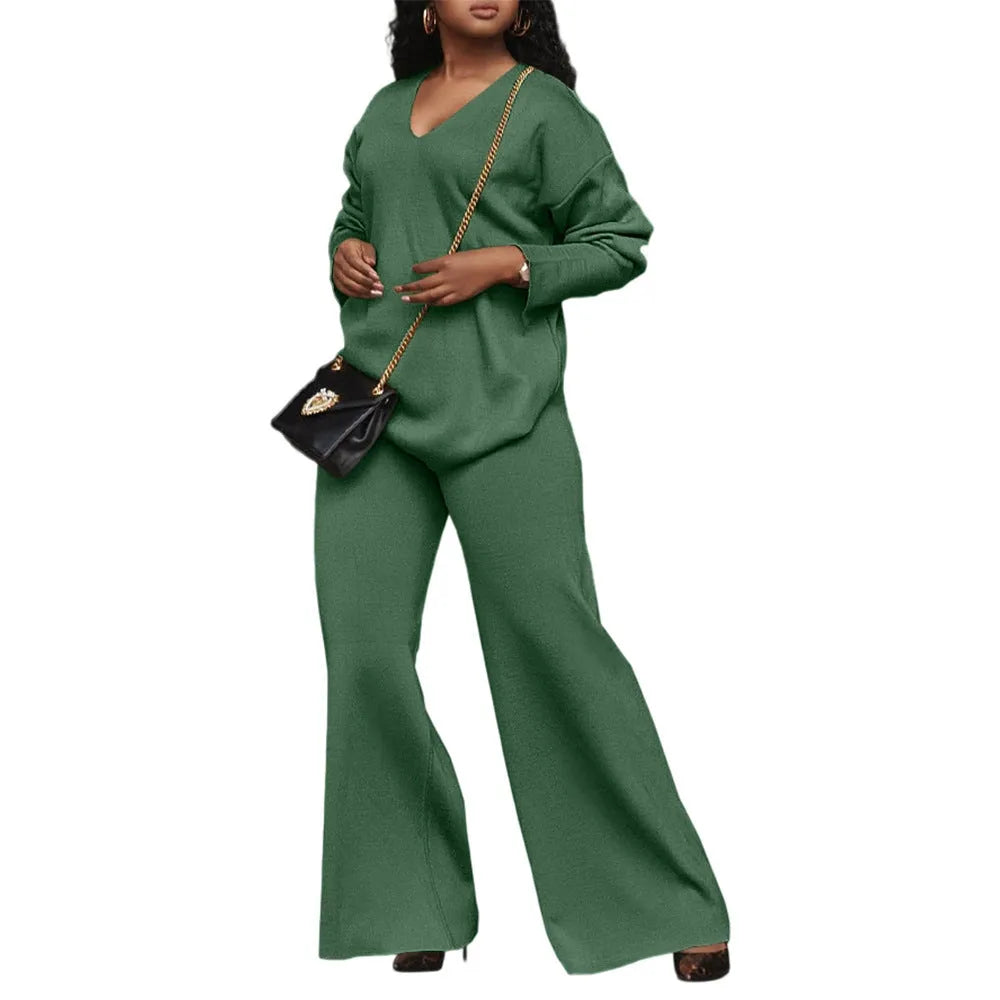 Women's brown suede two-piece suit with split sleeve detail on the long-sleeved top and matching trousers.
