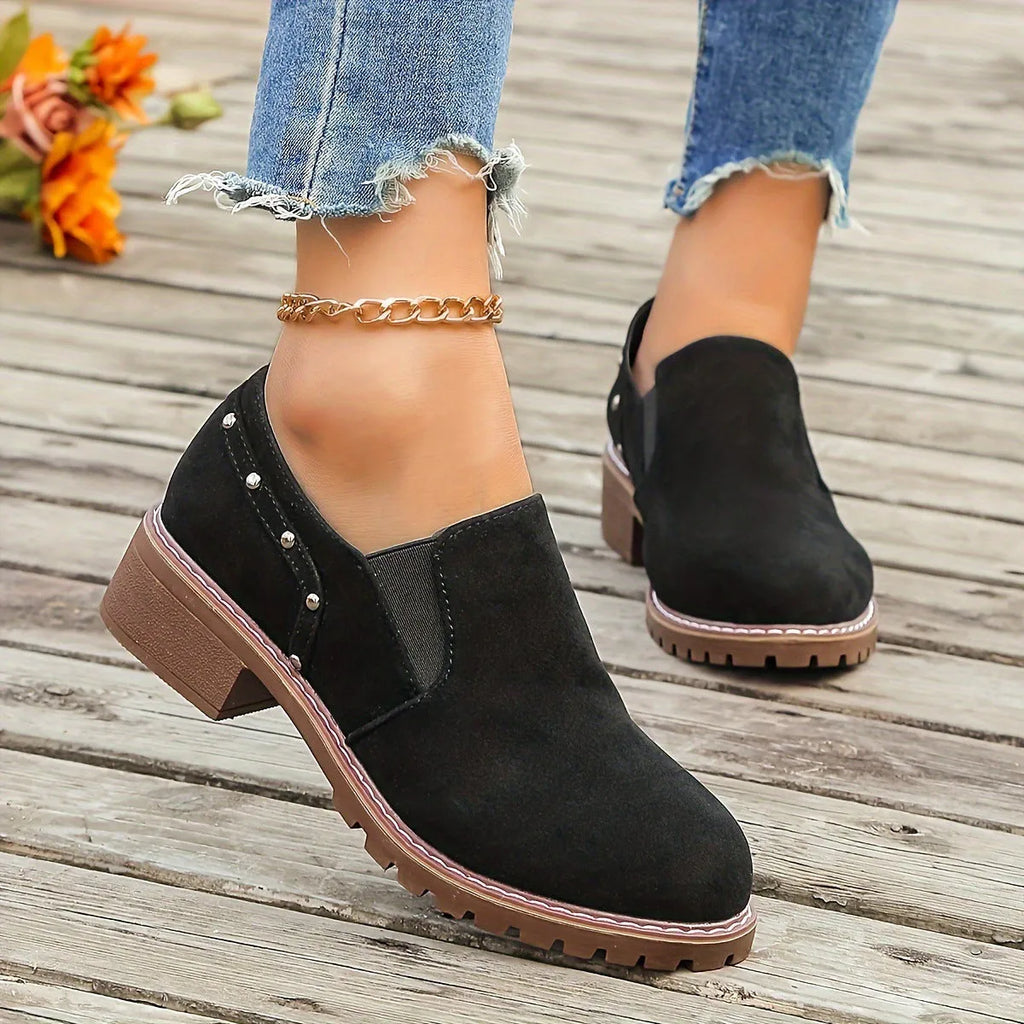 Women's light brown suede ankle boots with a low stout heel and elastic band at the ankle.