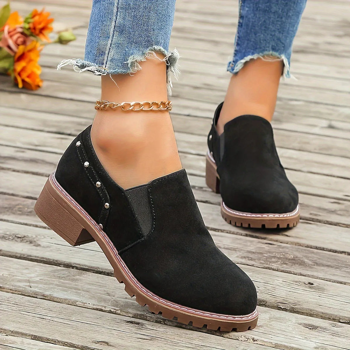Women's light brown suede ankle boots with a low stout heel and elastic band at the ankle.