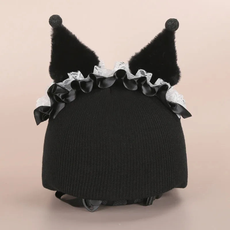 Plush fabric ski helmet decoration with cartoon design on a black ski helmet.