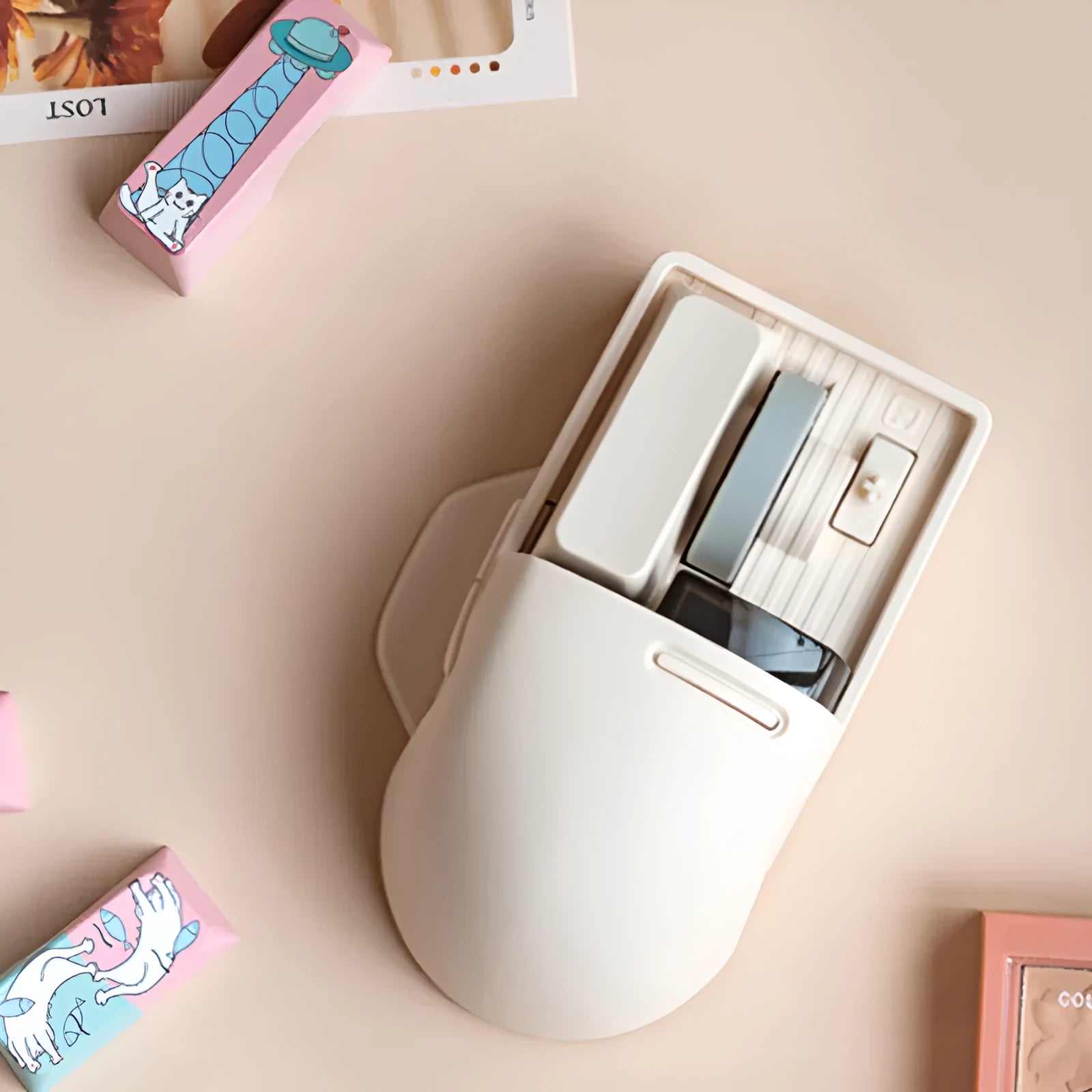 Xiaoqiao tofu-coloured wireless mouse with multiple buttons beside its Type-C charging cable and wireless receiver.