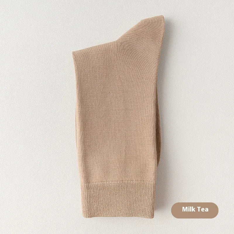 Men's solid colour pure cotton mid-calf business socks in beige, black, grey and blue shown folded.