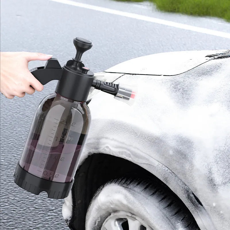 Black hand-held spray sprayer with 2 litre capacity, ergonomic handle, and two nozzles for watering and cleaning.