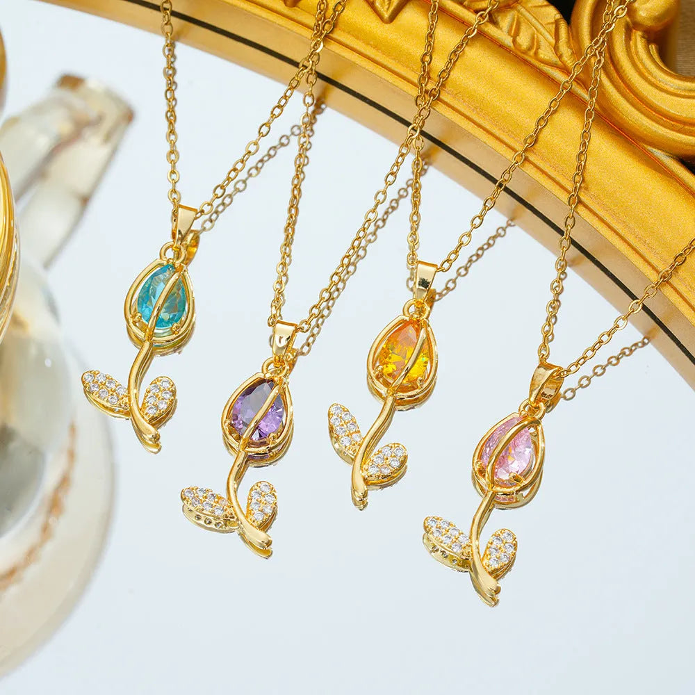 Gold electroplated tulip flower pendant on an adjustable titanium steel necklace chain.