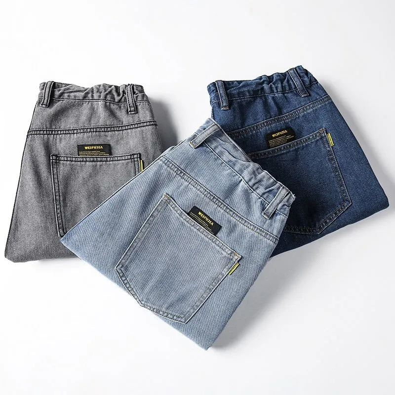Men's loose straight-leg jeans in cotton denim, shown in dark blue, with a zipper fly and mid-rise waist.