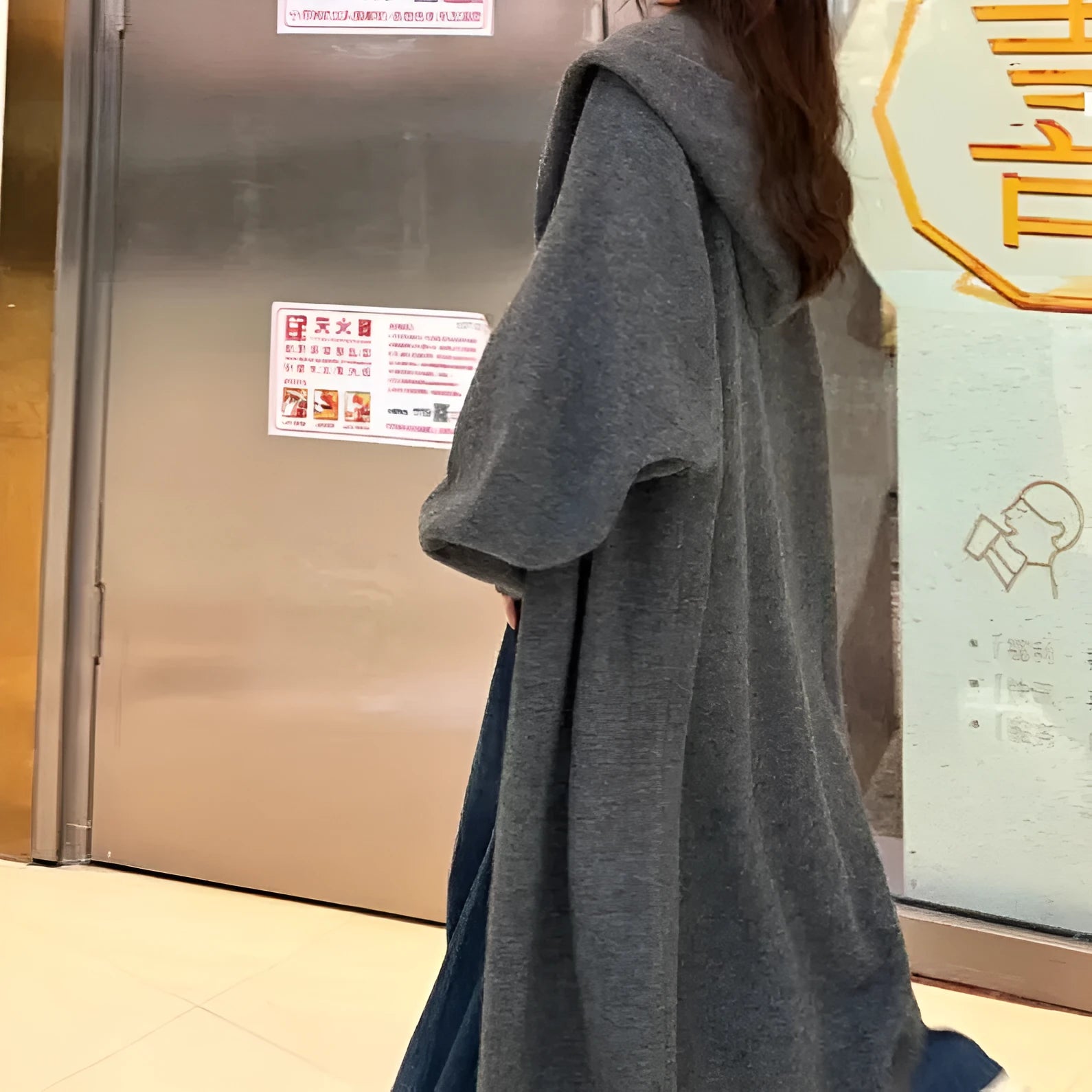 Women's long hooded cardigan in wool blend fabric showing below-the-knee length and loose fit silhouette