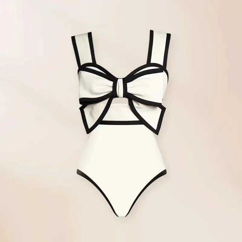 Female one-piece swim dress with round skirt and bow detail in polyester fabric