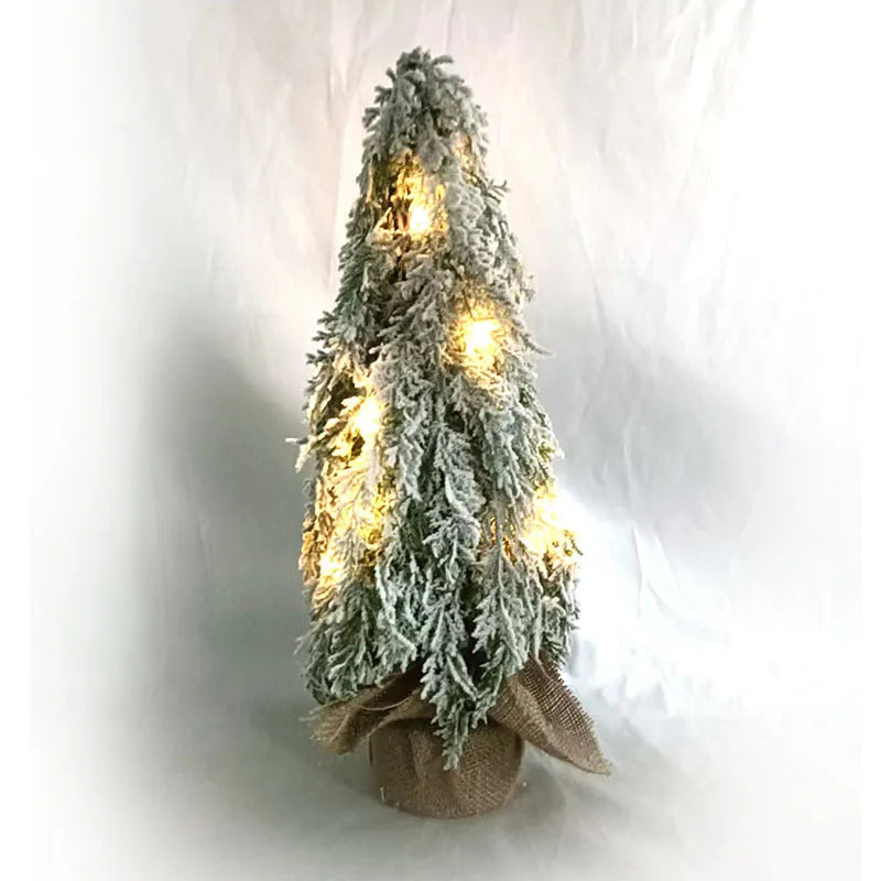 Small 24-inch white artificial Christmas tree with LED lights and snow-covered branches on a desktop.