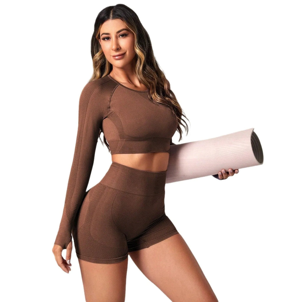 Women's black yoga suit set with long sleeve top and high-waisted tights on a mannequin.