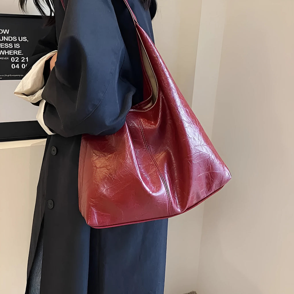 Soft leather shoulder bag in black with sandwich pocket design and shoulder strap