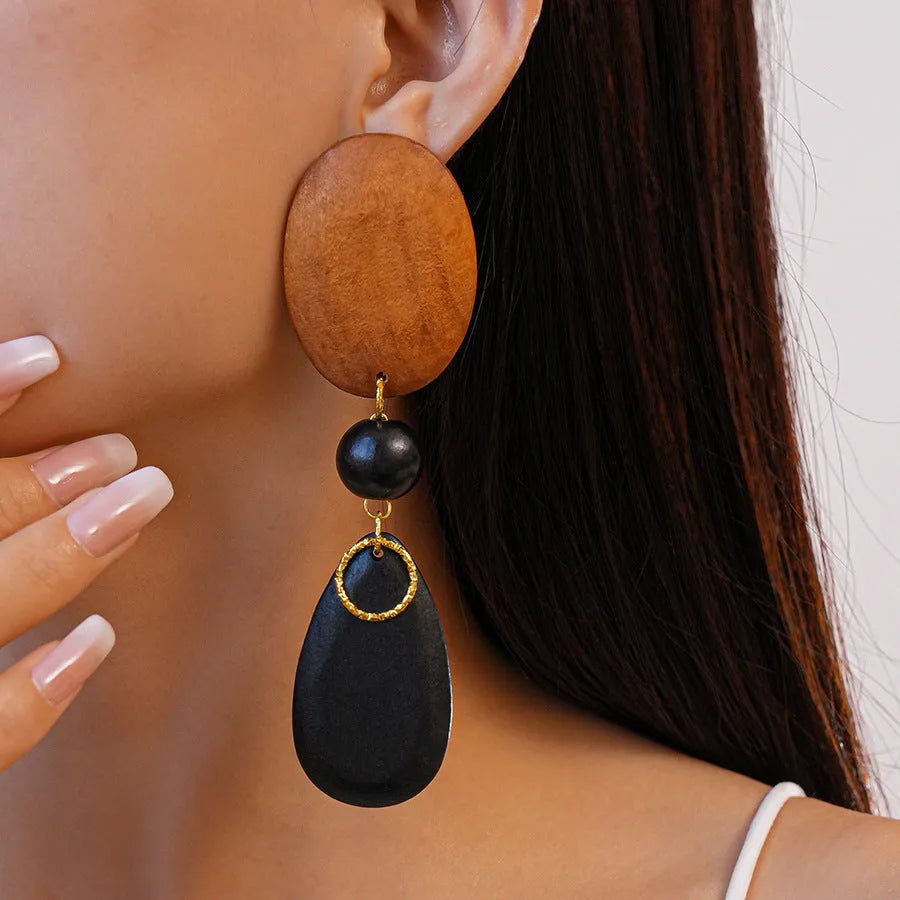 Brown-black wooden earrings with elliptical design and silver needle details for women